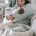 Mother with newborn baby on couch