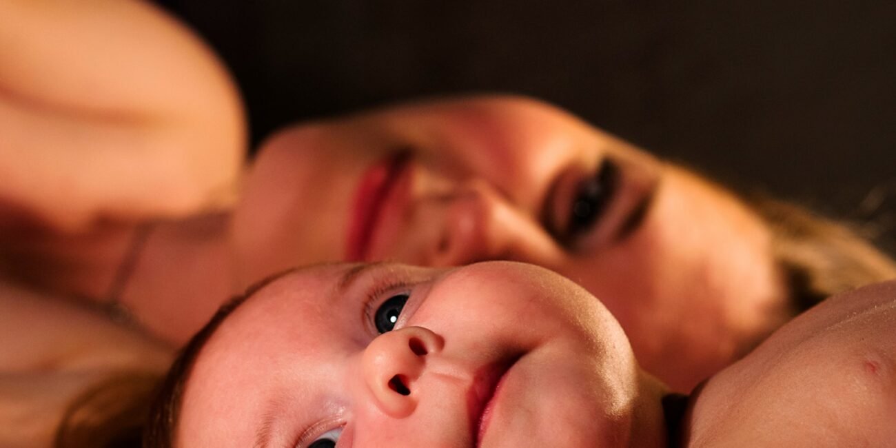 shallow focus photography of baby beside woman